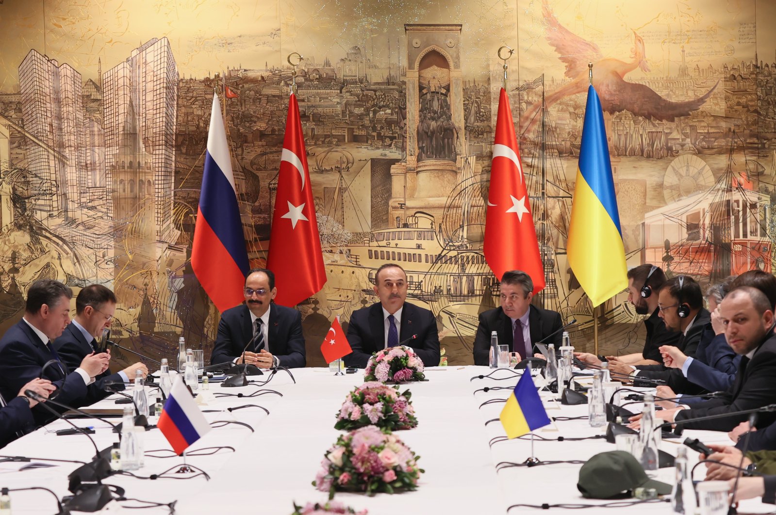 Foreign Minister Mevlüt Çavuşoğlu speaks with Russian and Ukrainian delegations after day one of peace talks ends in Istanbul, Turkey, March 29, 2022. (AA Photo)
