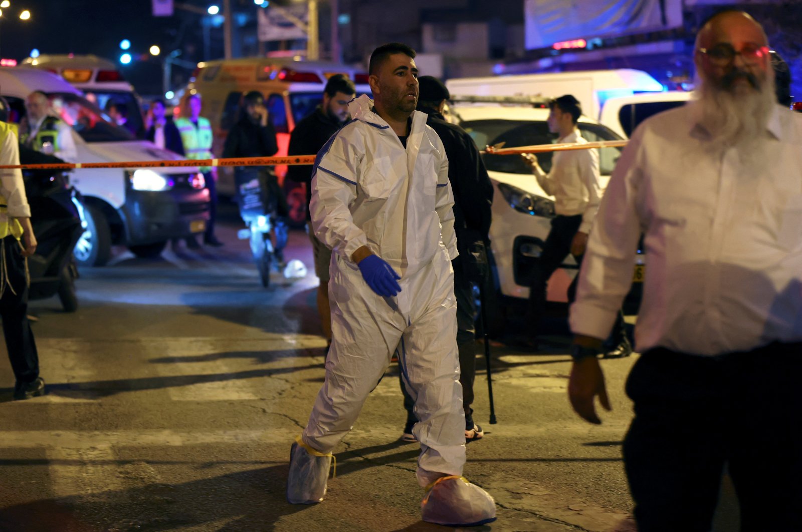 Israeli police forensics experts work at the scene of an attack in which people were killed by a gunman on a main street in Bnei Brak, near Tel Aviv, Israel, March 29, 2022. (Reuters Photo)