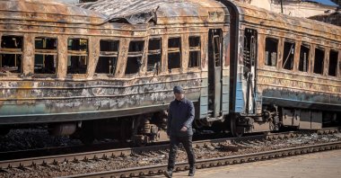 A man walks in front of a destroyed train in the northeastern city of Trostianets, Ukraine, March 29, 2022. (AFP Photo)