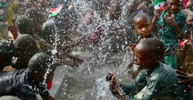 Children play with water at the well opened by TDV, in Maradi, Niger, March 25, 2022. (AA PHOTO)