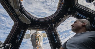 U.S. astronaut and Expedition 66 Flight Engineer Mark Vande Hei peers at the Earth below from inside the seven-windowed cupola, the International Space Station&#039;s window to the world, Feb. 4, 2022. (NASA via AP)