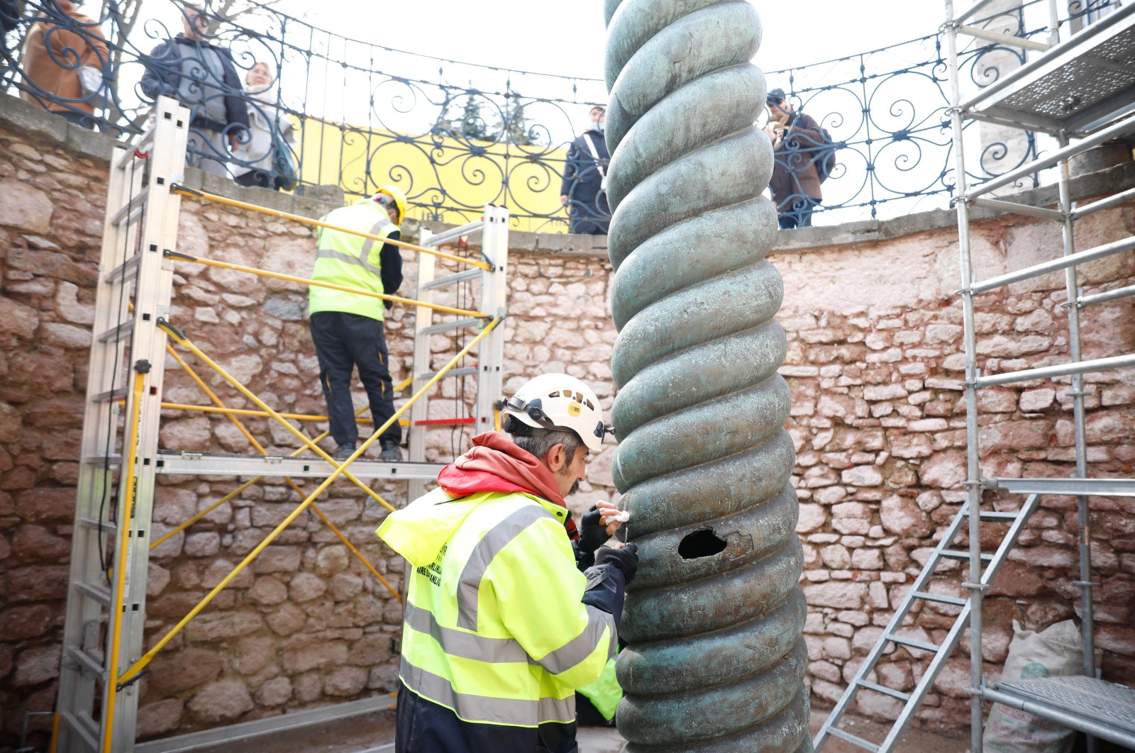 Restorers work on the Serpent Column, Sultanahmet square, Istanbul, March 29, 2021. (DHA) 