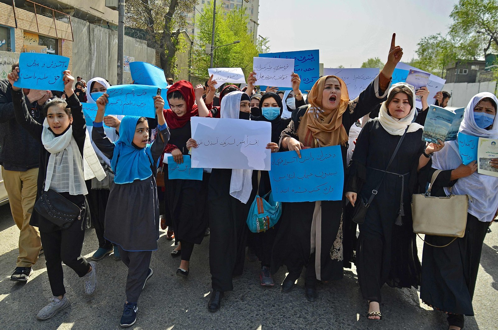 Afghan women and girls take part in a protest in front of the Ministry of Education to reopen high schools for girls, Kabul, Afghanistan, March 26, 2022. (AFP Photo)