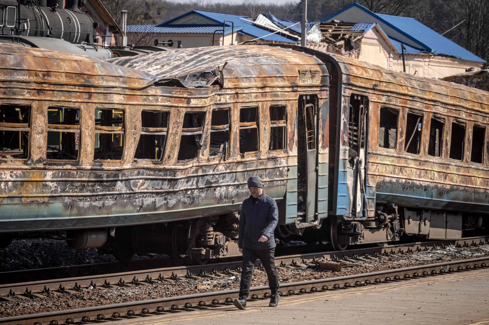 A man walks in front of a destroyed train in the northeastern city of Trostianets, Ukraine, March 29, 2022. (AFP Photo)