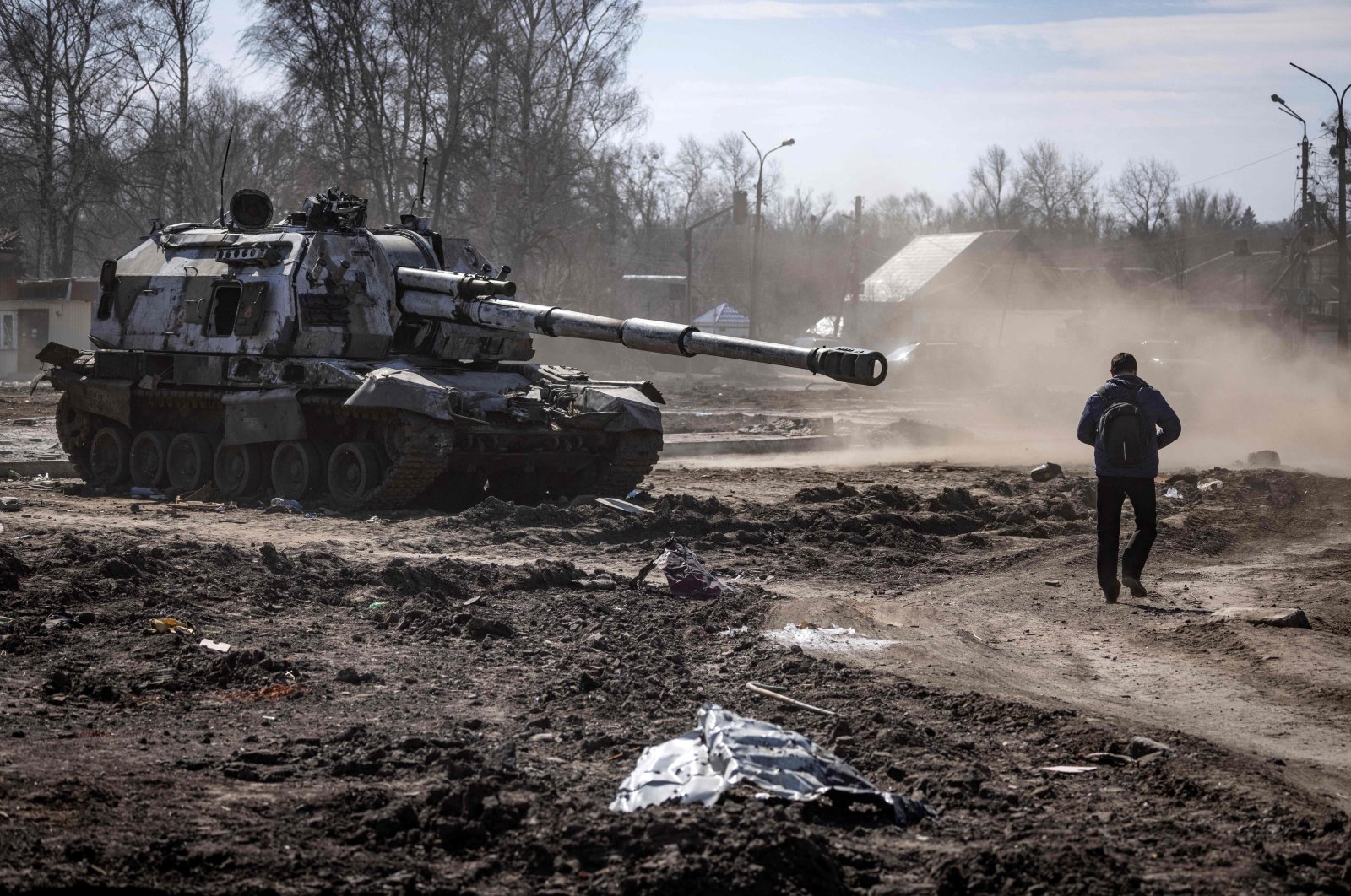 A resident walks near a damaged Russian tank in the northeastern city of Trostianets, Ukraine, March 29, 2022. (AFP Photo)