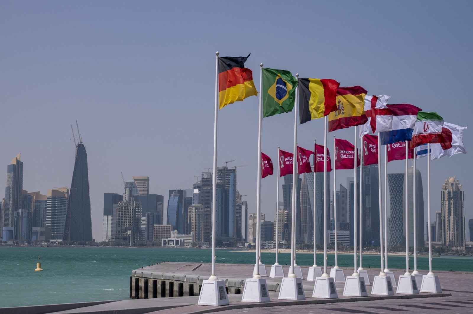 Flags of some of the qualified countries of the World Cup wave in Doha, Qatar, March 29, 2022. (AP Photo)