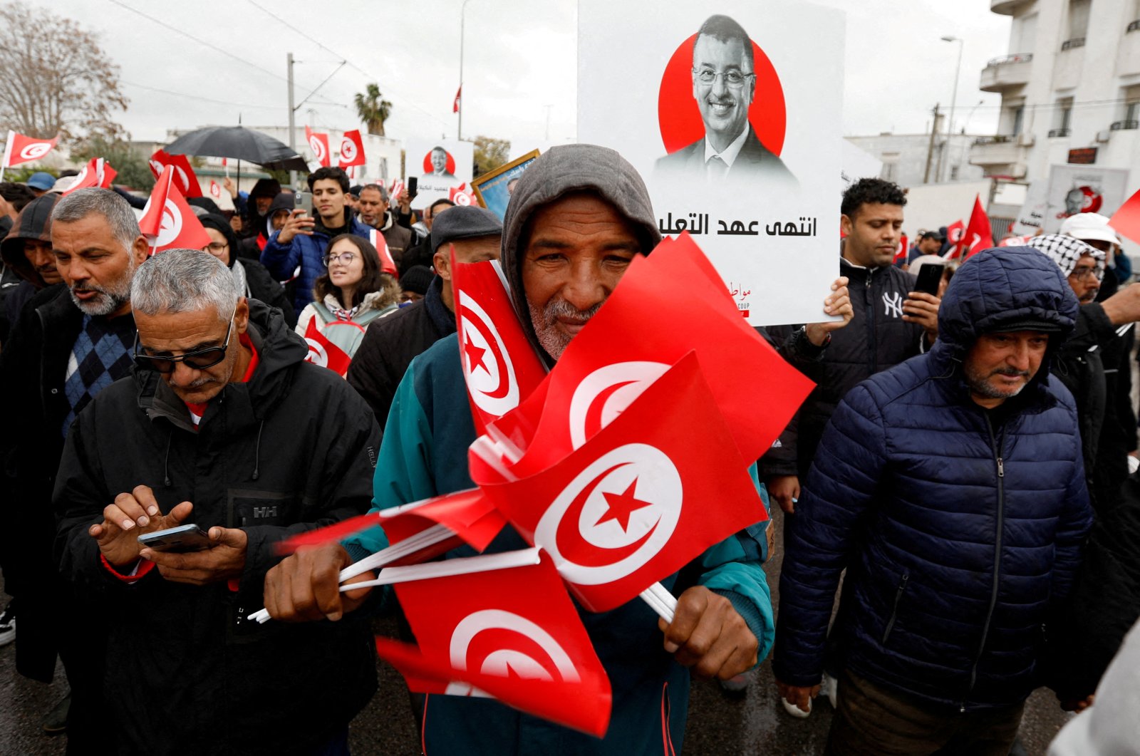 A man holds Tunisian national flags during a protest against Tunisian President Kais Saied&#039;s seizure of governing powers, in Tunis, Tunisia March 20, 2022. (Reuters Photo)