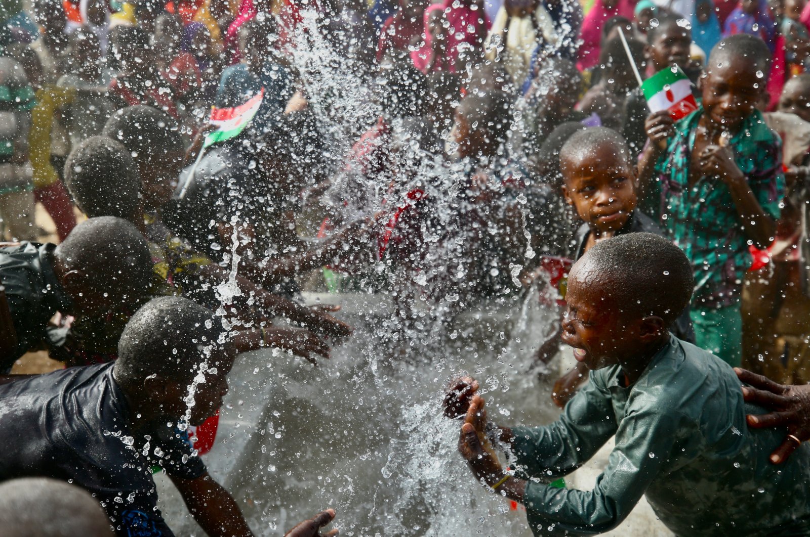 Children play with water at the well opened by TDV, in Maradi, Niger, March 25, 2022. (AA PHOTO)