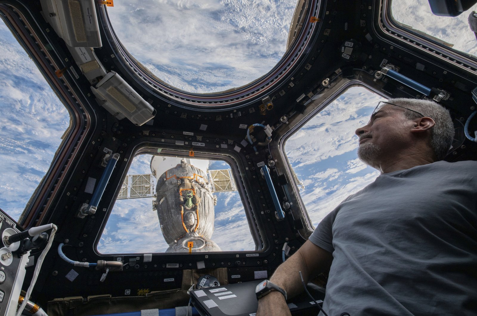 U.S. astronaut and Expedition 66 Flight Engineer Mark Vande Hei peers at the Earth below from inside the seven-windowed cupola, the International Space Station&#039;s window to the world, Feb. 4, 2022. (NASA via AP)