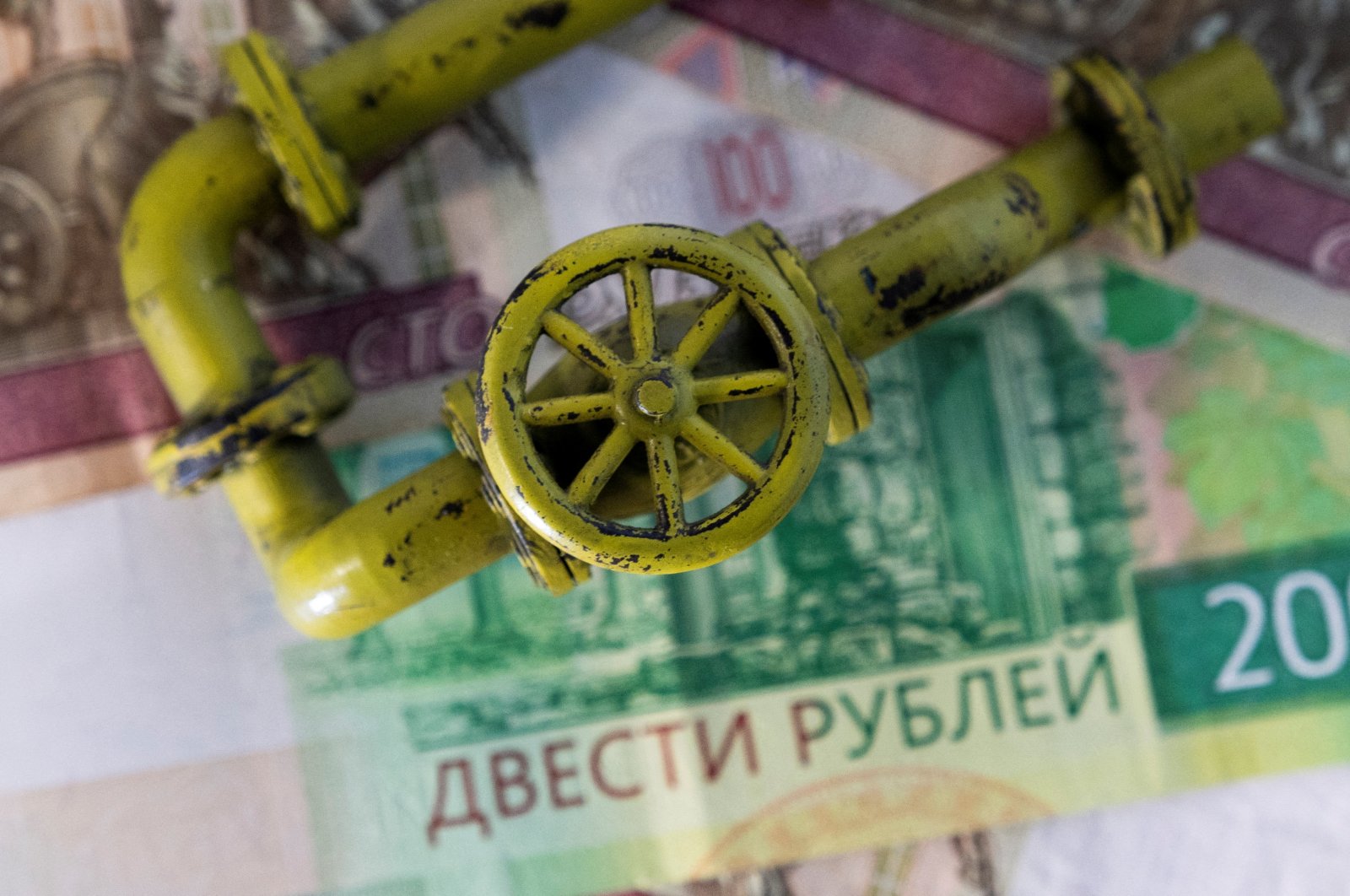 A model of the natural gas pipeline is placed on Russian ruble banknotes in this illustration taken on March 23, 2022. (Reuters Photo)