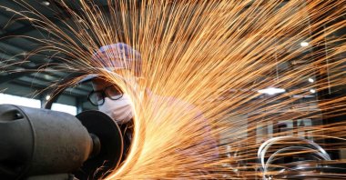 A worker wearing a face mask works on a production line manufacturing steel bicycle parts at a factory, as the country is hit by the coronavirus outbreak, Hangzhou, Zhejiang province, China, March 2, 2020. (Reuters Photo)