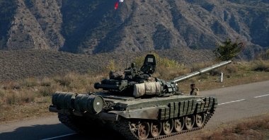 A service member of the Russian peacekeeping troops stands next to a tank near the border with Armenia, following the signing of a deal to end the military conflict between Azerbaijan and ethnic Armenian forces, in the region of Nagorno-Karabakh, Nov. 10, 2020. (Reuters File Photo)