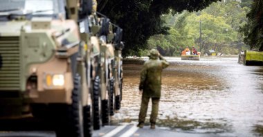 This handout photograph taken on March 30, 2022, and released by the Australian Defence Force shows Australian Army soldiers in Bushmaster protected mobility vehicles are on standby to conduct evacuation tasks with the local State Emergency Services (SES) due to rising flood waters in New South Wales town of Lismore, in support of Operation Flood Assist 2022. (AFP Photo)