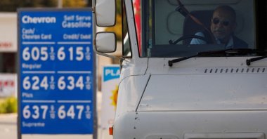 A U.S. postal worker puts his seatbelt on after filing up his vehicle at a gas station in Garden Grove, California, U.S., March 29, 2022. (Reuters Photo)