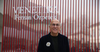 Ferzan Özpetek poses in front of the red cube where his installation &quot;Venetika&quot; is exhibited at MAXXI, Rome, Italy, March 28, 2022. (AA Photo)