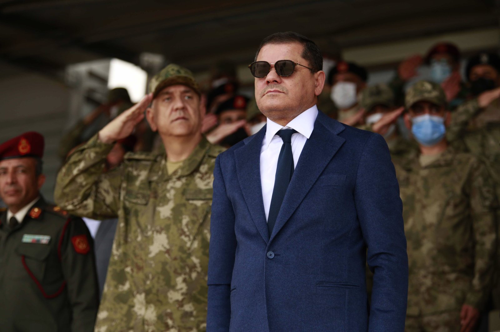Prime Minister Abdul Hamid Dbeibah (C) and the commander of the Turkish training mission in Libya attend the graduation ceremony of a batch of Libyan army cadets, in Tripoli, Libya, Feb. 8, 2022. (AP File Photo)