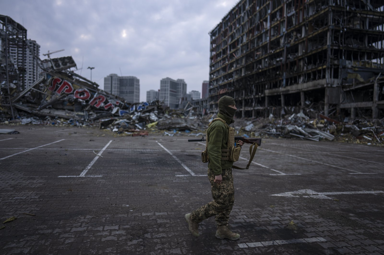 A soldier walks the amid the destruction caused after shelling of a shopping center, in Kyiv, Ukraine, March 30, 2022. (AP Photo)