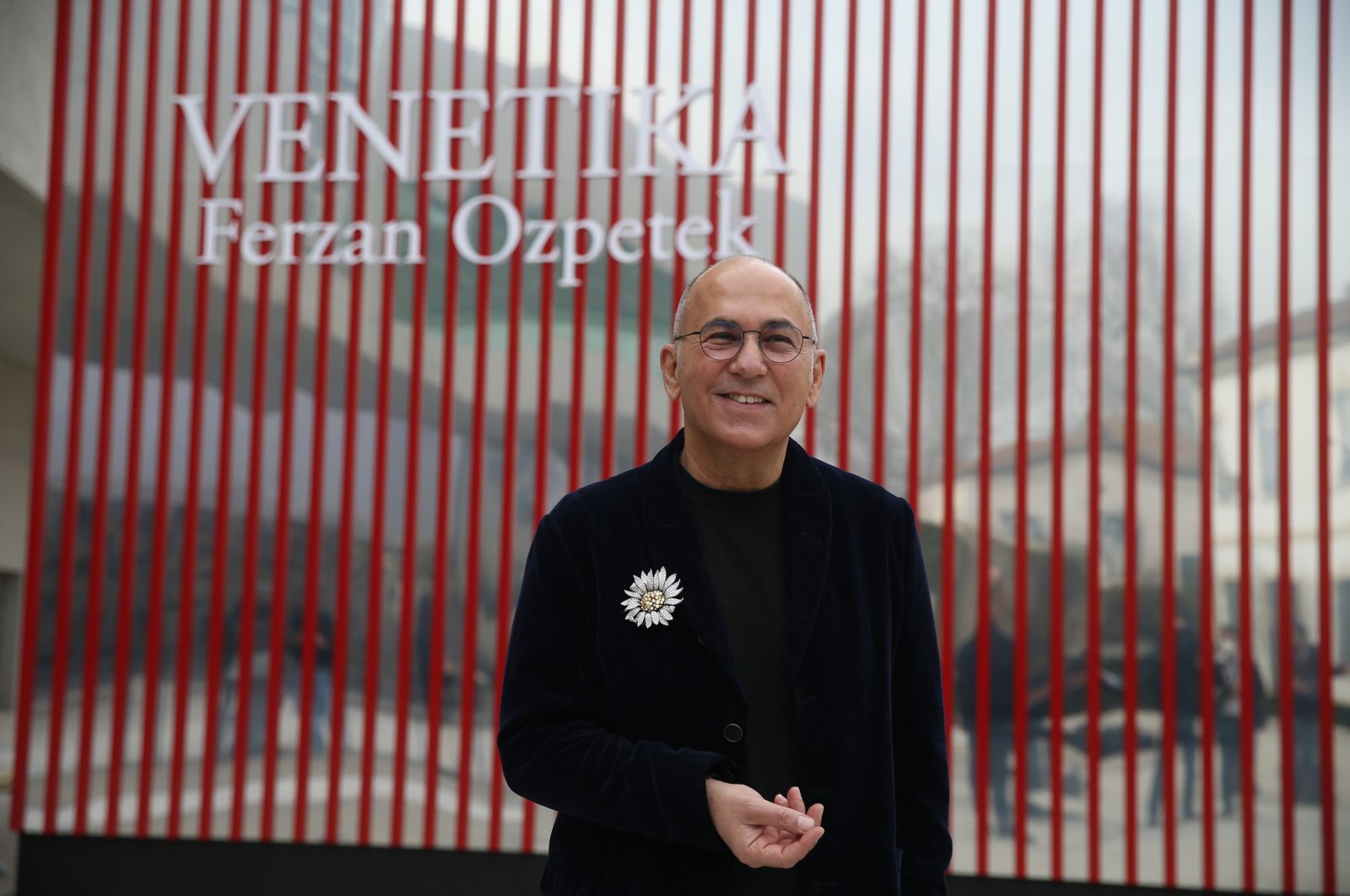Ferzan Özpetek poses in front of the red cube where his installation &quot;Venetika&quot; is exhibited at MAXXI, Rome, Italy, March 28, 2022. (AA Photo)