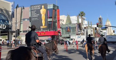 Los Angeles Police Officers (LAPD) are seen patrolling Hollywood Boulevard on horses as the city gets ready for the 94th Academy Awards in Hollywood, California on March 23, 2022. (AFP)