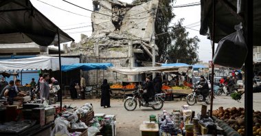 Syrians gather at a market as they prepare for the Muslim holy month of Ramadan, in the war-ravaged Syrian town of Ariha in the opposition-held Idlib province, northwestern Syria, March 31, 2022. (AFP)