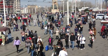 People walk in Taksim Square, in Istanbul, Turkey, March 27, 2022. (IHA PHOTO)