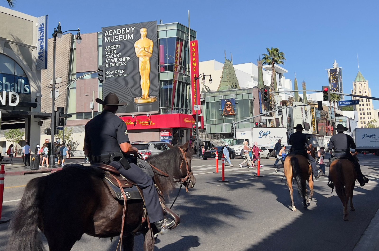 Los Angeles Police Officers (LAPD) are seen patrolling Hollywood Boulevard on horses as the city gets ready for the 94th Academy Awards in Hollywood, California on March 23, 2022. (AFP)