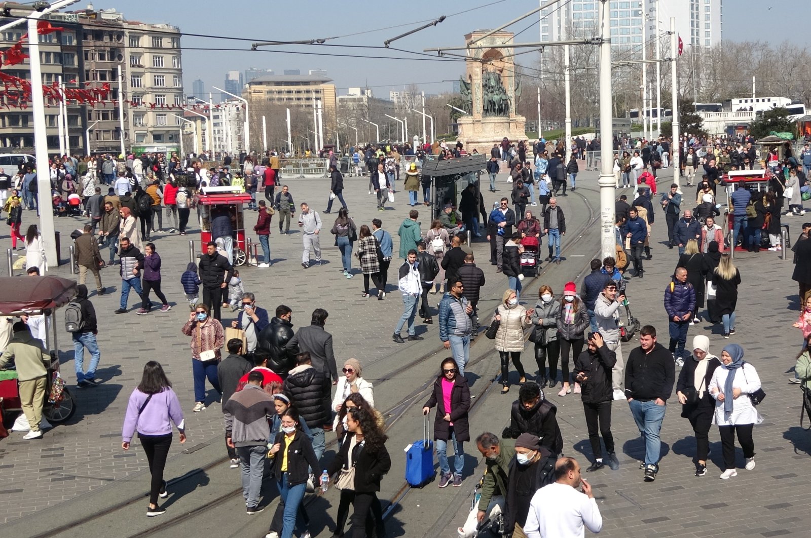 People walk in Taksim Square, in Istanbul, Turkey, March 27, 2022. (IHA PHOTO)