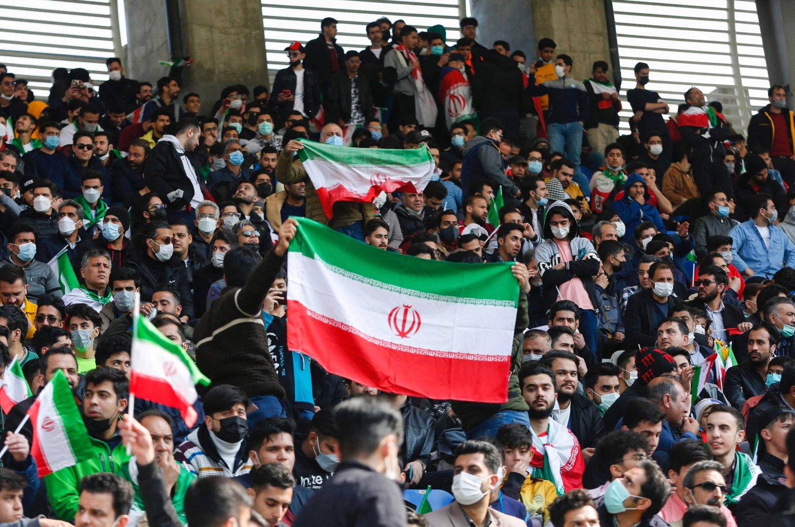 Iran supporters wave the national flag during a World Cup qualifier against Lebanon, Mashhad, Iran, March 29, 2022. (AFP Photo)
