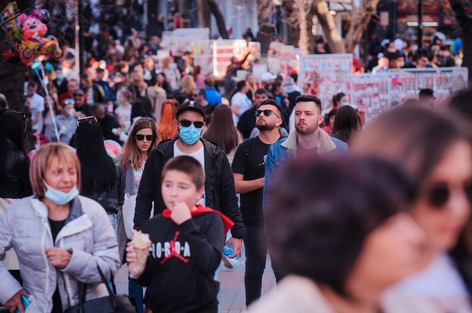 People with masks are visible among the crowd on the main street in Plovdiv, Bulgaria, on February 27th 2021. (Reuters File Photo)