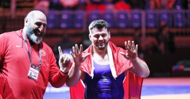 Turkish wrestler Rıza Kayaalp and a team member celebrate his 11th gold medal in the European Wrestling Championships in Budapest, Hungary, April 2, 2022. (DHA Photo)