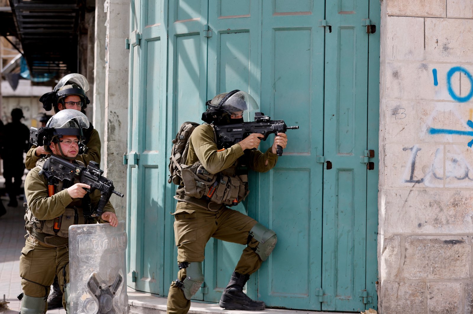 An Israeli soldier takes aim at Palestinian protesters in Hebron, in the Israeli-occupied West Bank, Palestine, April 1, 2022. (Reuters Photo)