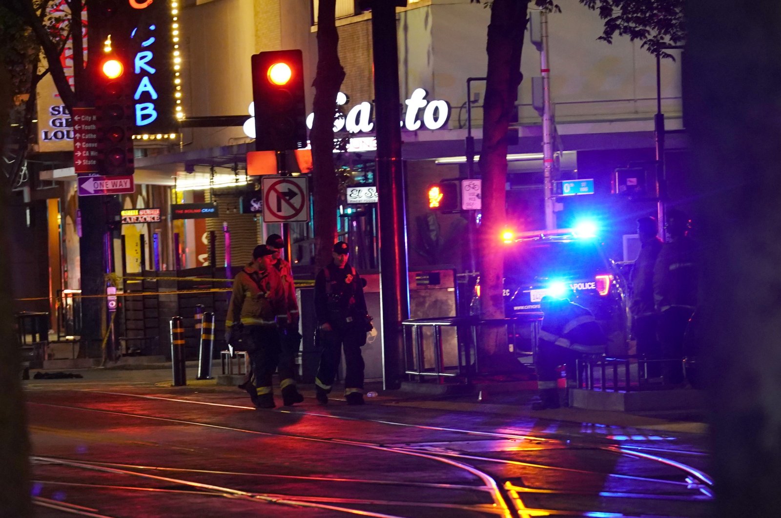 Emergency personnel walk near the scene of an apparent mass shooting in Sacramento, California, U.S., April 3, 2022. (AP Photo)