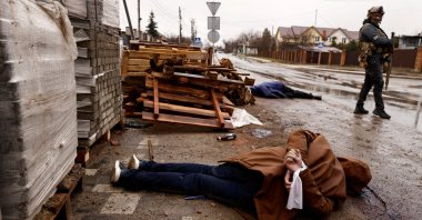 The body of an individual who residents say was shot by Russian soldiers lies in the street with their hands bound behind their back, Bucha, Ukraine, April 3, 2022. (Reuters Photo)