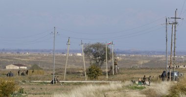 Azerbaijani frontier guards (L) and Nagorno-Karabakh&#039;s military are seen controlling both sides of a new border between the liberated region of Nagorno-Karabakh and Azerbaijan, Tuesday, Nov. 24, 2020. (AP File Photo)