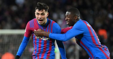 Barcelona's Pedri (L) celebrates with teammate Ousmane Dembele after scoring in a La Liga match against Sevilla, Barcelona, Spain, April 3, 2022. (AFP Photo)