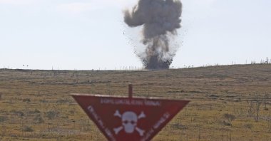 Unexploded ammunition is detonated during a demo mine-clearing operation by the Azerbaijan National Agency for Mine Action (ANAMA) to further operations to clear mines previously planted by Armenian forces, Fuzuli, Azerbaijan, Feb. 27, 2021. (Photo by Getty Images)