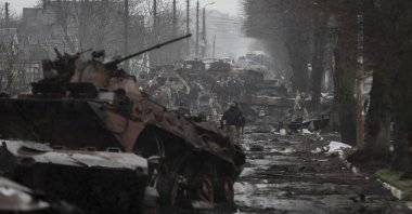 Ukrainian soldiers inspect destroyed Russian military machinery in the areas recaptured by the Ukrainian army in the city of Bucha, Ukraine, April 3, 2022. (EPA Photo)