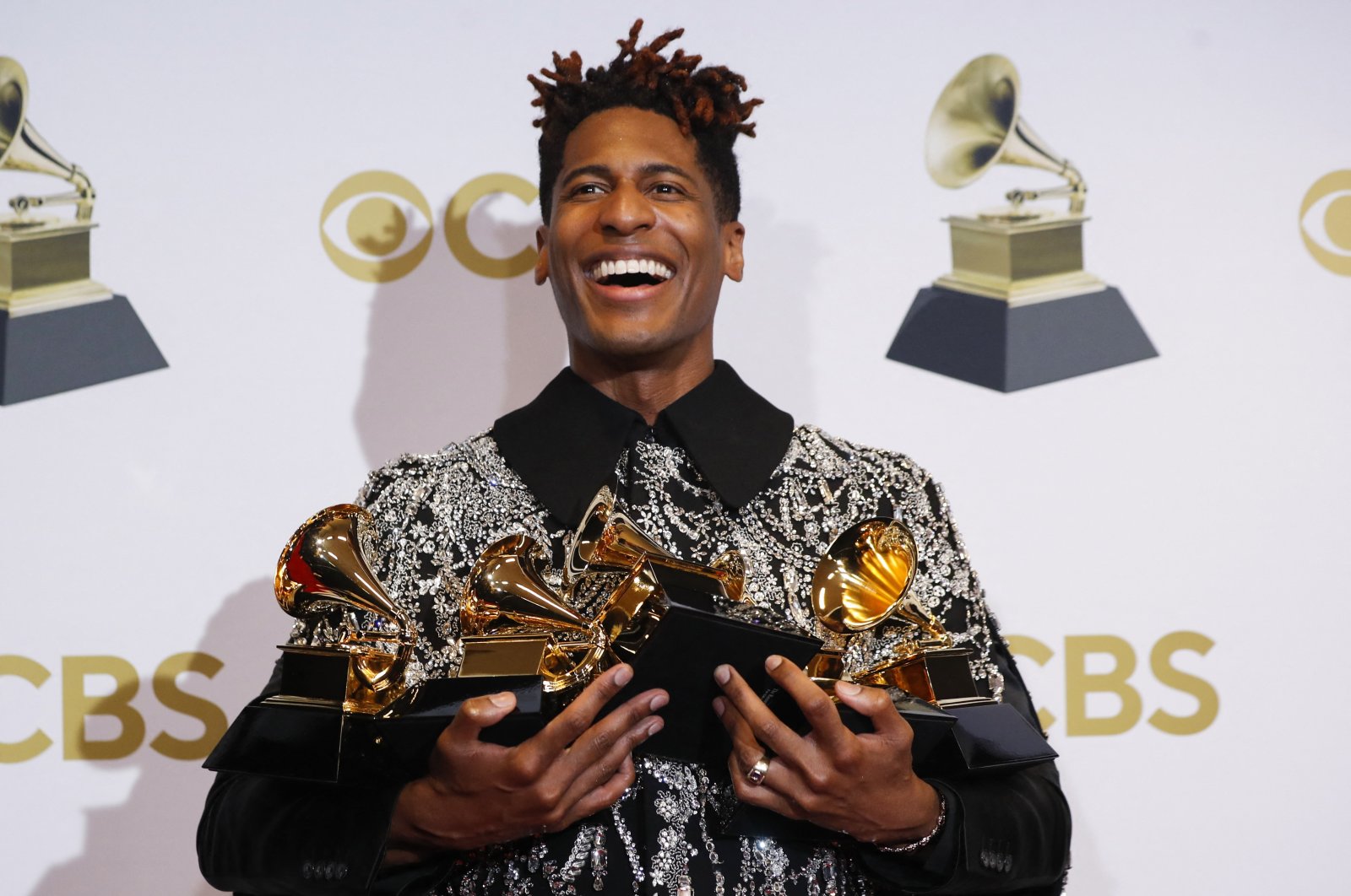Jon Batiste poses with their Grammys for Best American Roots Performance for &quot;Cry,&quot; album of the year for &quot;We Are,” Best American roots song, best music video and best score soundtrack for visual media for &quot;Soul,&quot; at the 64th Annual Grammy Awards at the MGM Grand Garden Arena in Las Vegas, Nevada, U.S., April 3, 2022. (REUTERS)