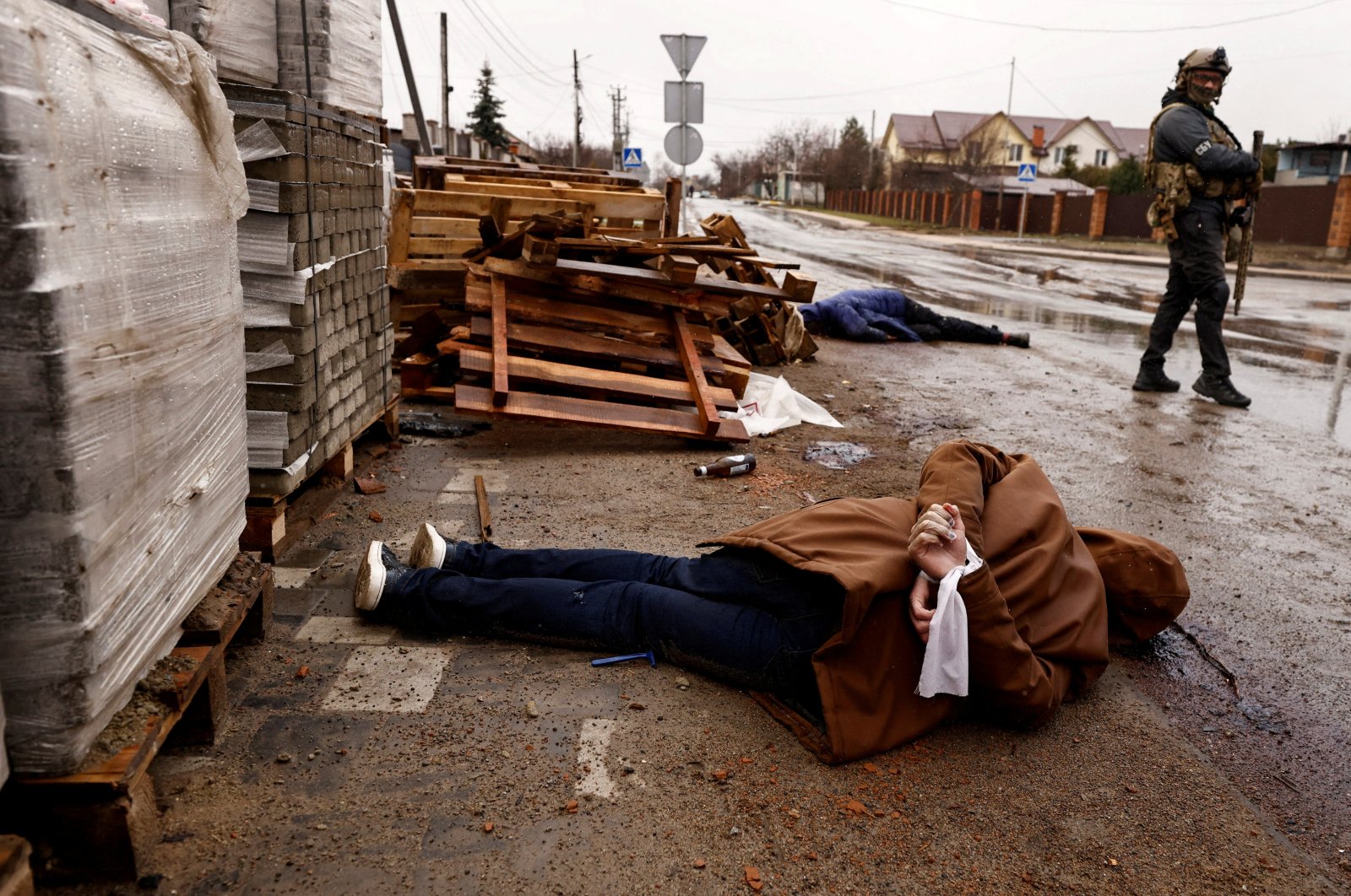 The body of an individual who residents say was shot by Russian soldiers lies in the street with their hands bound behind their back, Bucha, Ukraine, April 3, 2022. (Reuters Photo)