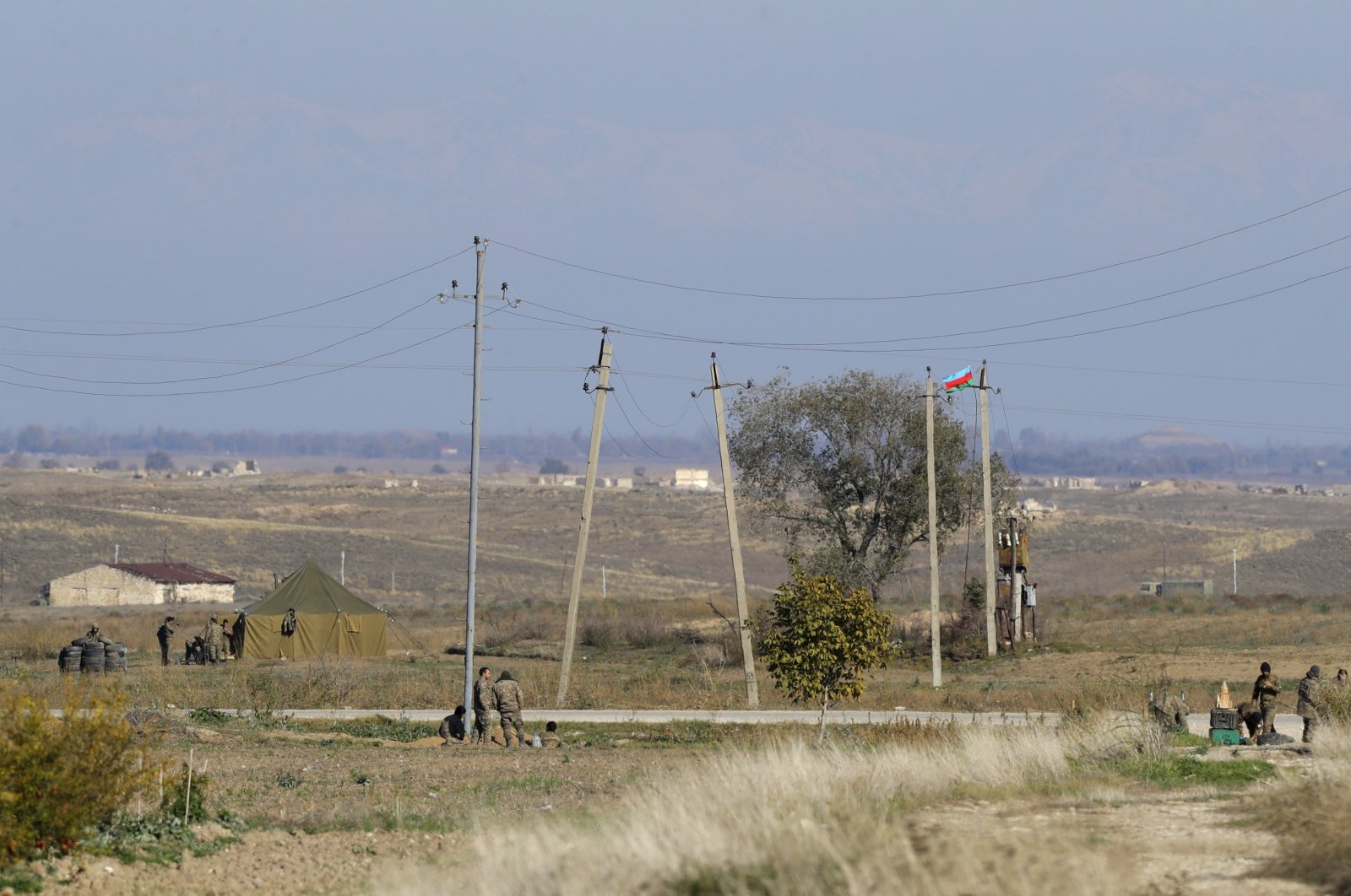 Azerbaijani frontier guards (L) and Nagorno-Karabakh&#039;s military are seen controlling both sides of a new border between the liberated region of Nagorno-Karabakh and Azerbaijan, Tuesday, Nov. 24, 2020. (AP File Photo)