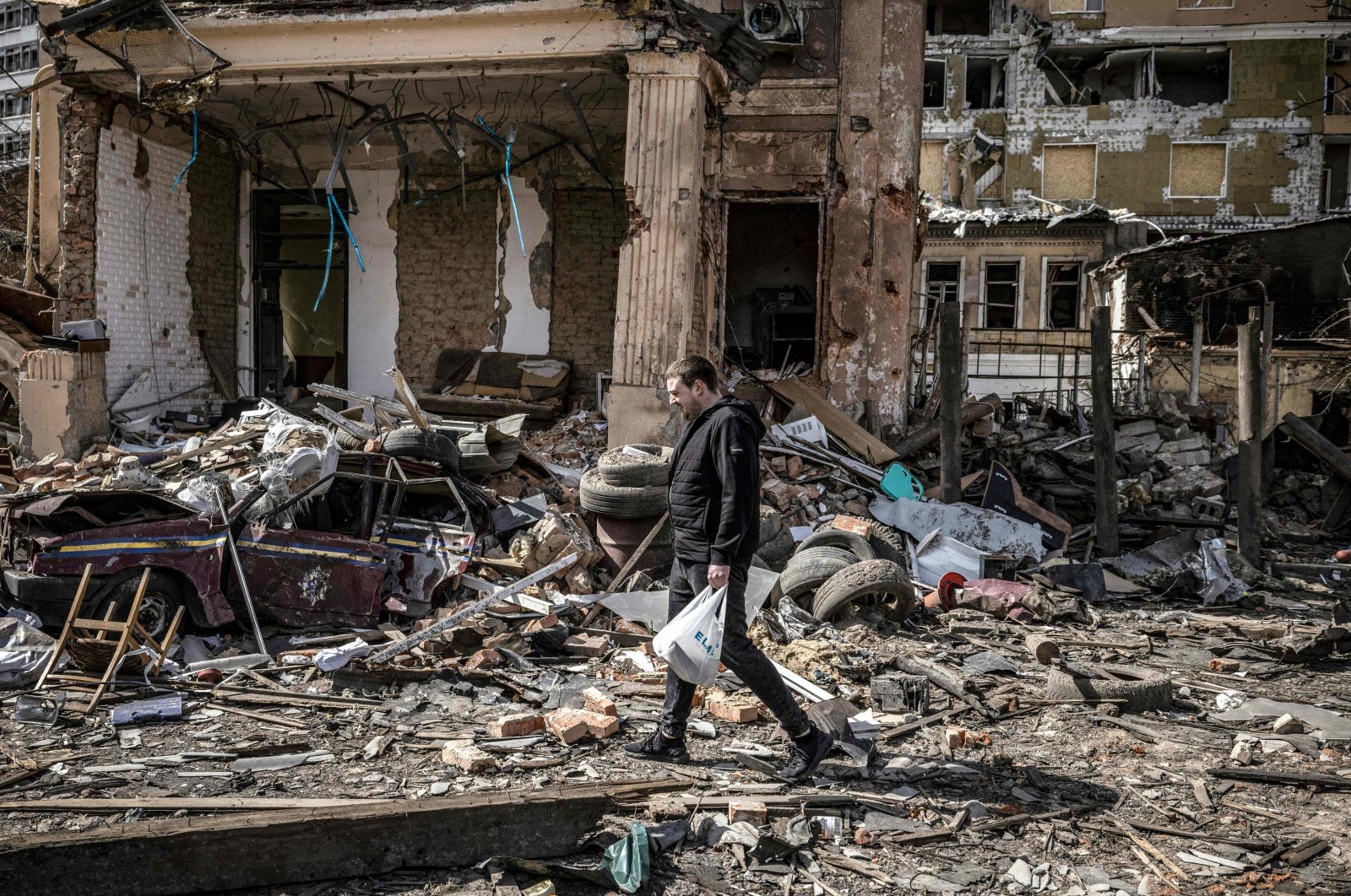A man walks in the rubble of a destroyed building in the eastern Ukraine city of Kharkiv, April 2, 2022. (AFP Photo)