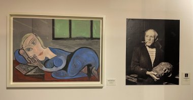 "Femme Couchee Lisant" by Picasso and a photo of the artist are seen at the Museum of Black Civilizations, Dakar, Senegal, April 2, 2022. (AA Photo)