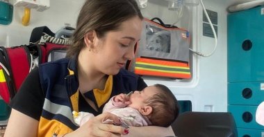 Emergency medical technician Büşra Durmaz holds the rescued baby she breastfed, Istanbul, Turkey, April 2, 2022. (IHA PHOTO)