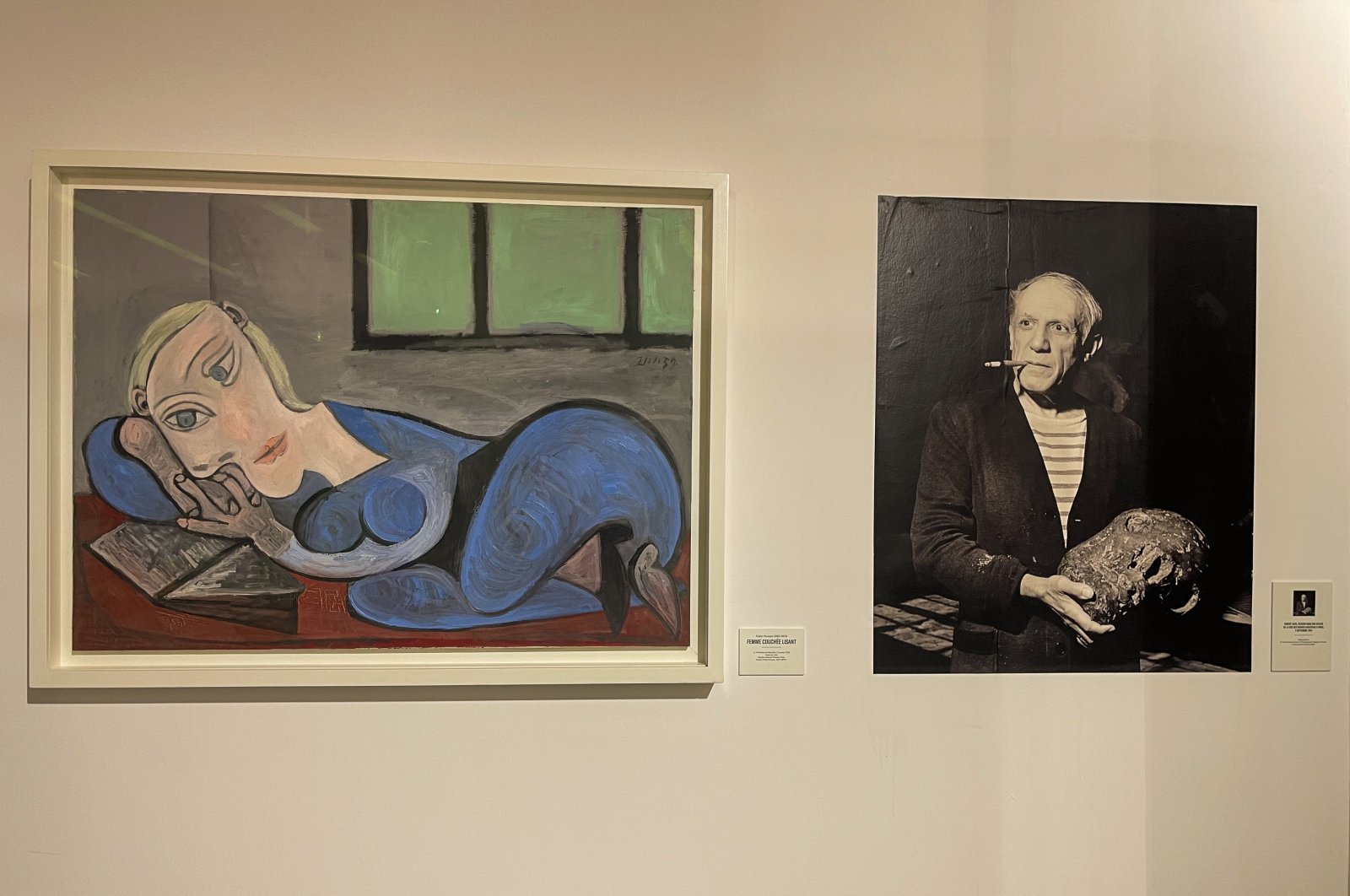 "Femme Couchee Lisant" by Picasso and a photo of the artist are seen at the Museum of Black Civilizations, Dakar, Senegal, April 2, 2022. (AA Photo)
