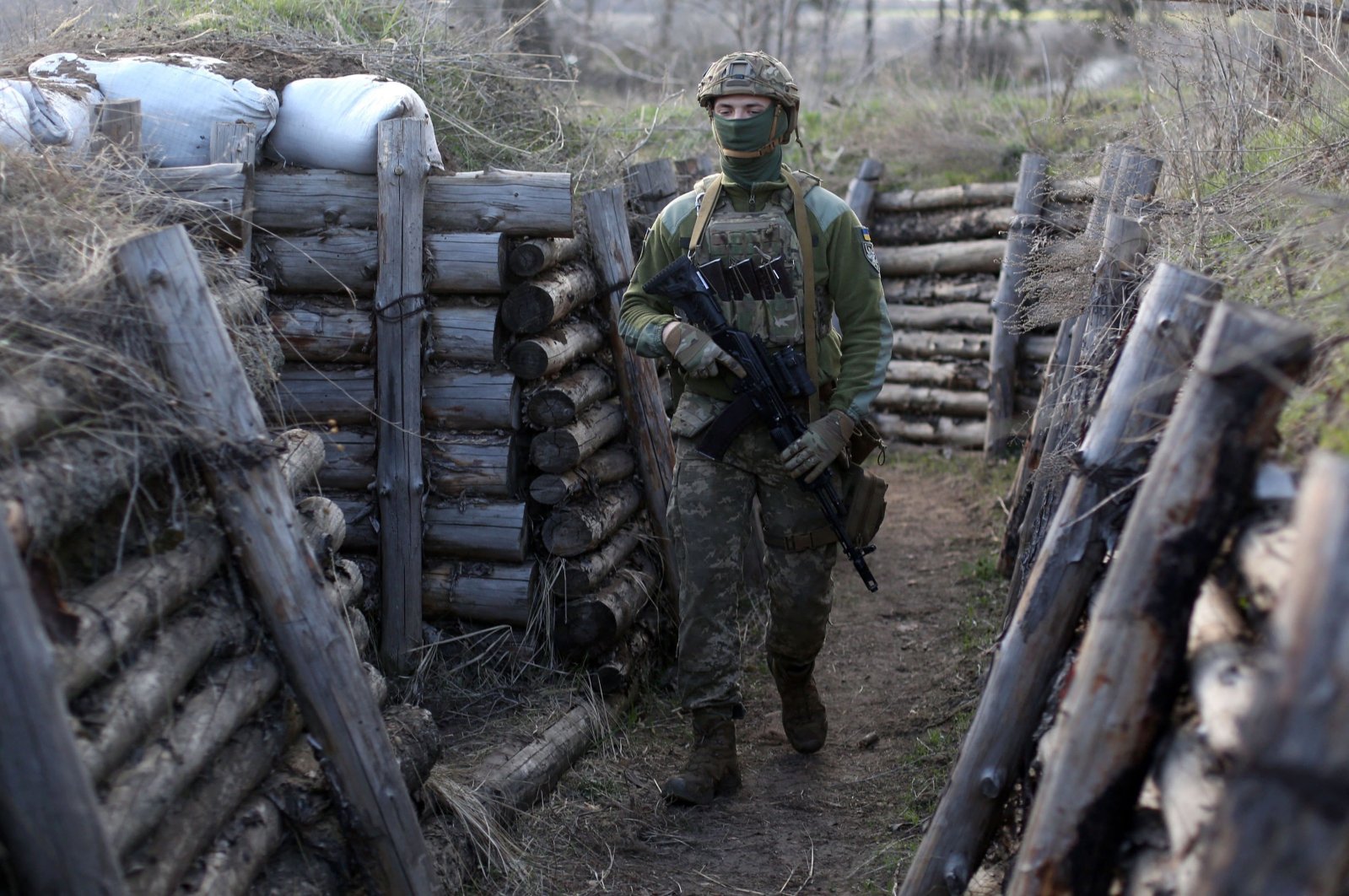 A Ukrainian soldier patrols along a trench in Schastya, Lugansk region, near the front line with Russia backed separatists, April 16, 2021. (AFP Photo)