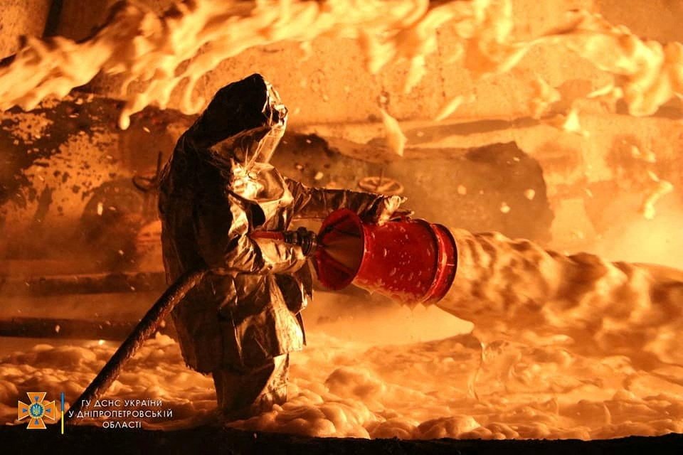 A firefighter works at a site of burning fuel storage facilities damaged by an airstrike, as Russia&#039;s attack on Ukraine continues, in the Dnipropetrovsk region, Ukraine, April 6, 2022. (Press service of the State Emergency Service of Ukraine via Reuters)