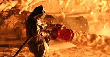 A firefighter works at a site of burning fuel storage facilities damaged by an airstrike, as Russia's attack on Ukraine continues, in the Dnipropetrovsk region, Ukraine, April 6, 2022. (Press service of the State Emergency Service of Ukraine via Reuters)