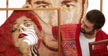 Fırat Neziroğlu poses with his works. (Courtesy of the artist) 