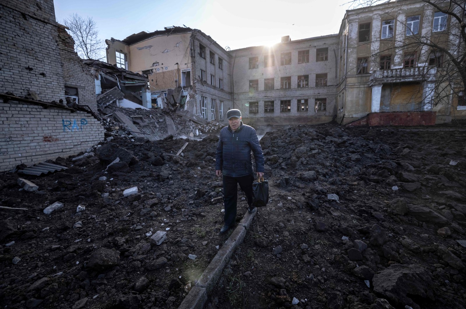 A man walks near a damaged school, next to a police building in Kramatorsk, Donbass Region of eastern Ukraine, April 5, 2022. (AFP Photo)