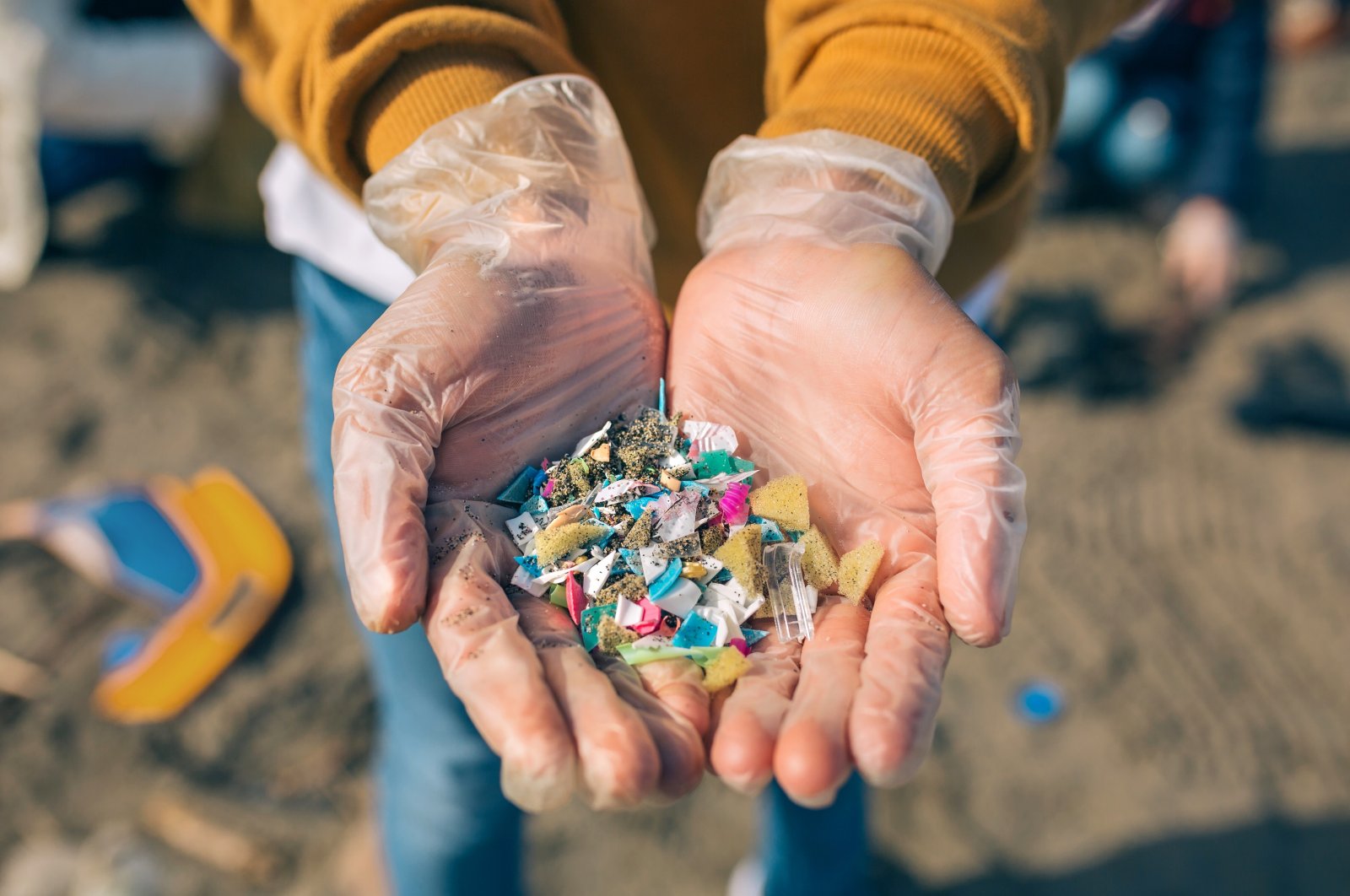 An environmentalist shows a handful of plastics, Istanbul, Turkey, April 6, 2022. (DHA Photo)
